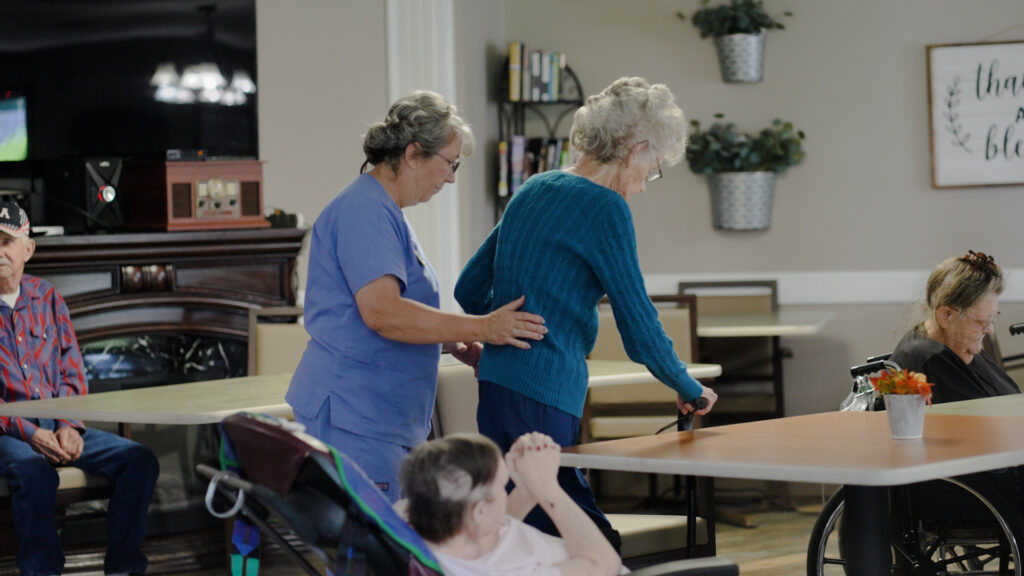 A long term care nurse assisting a woman at Beebe retirement center for respite care